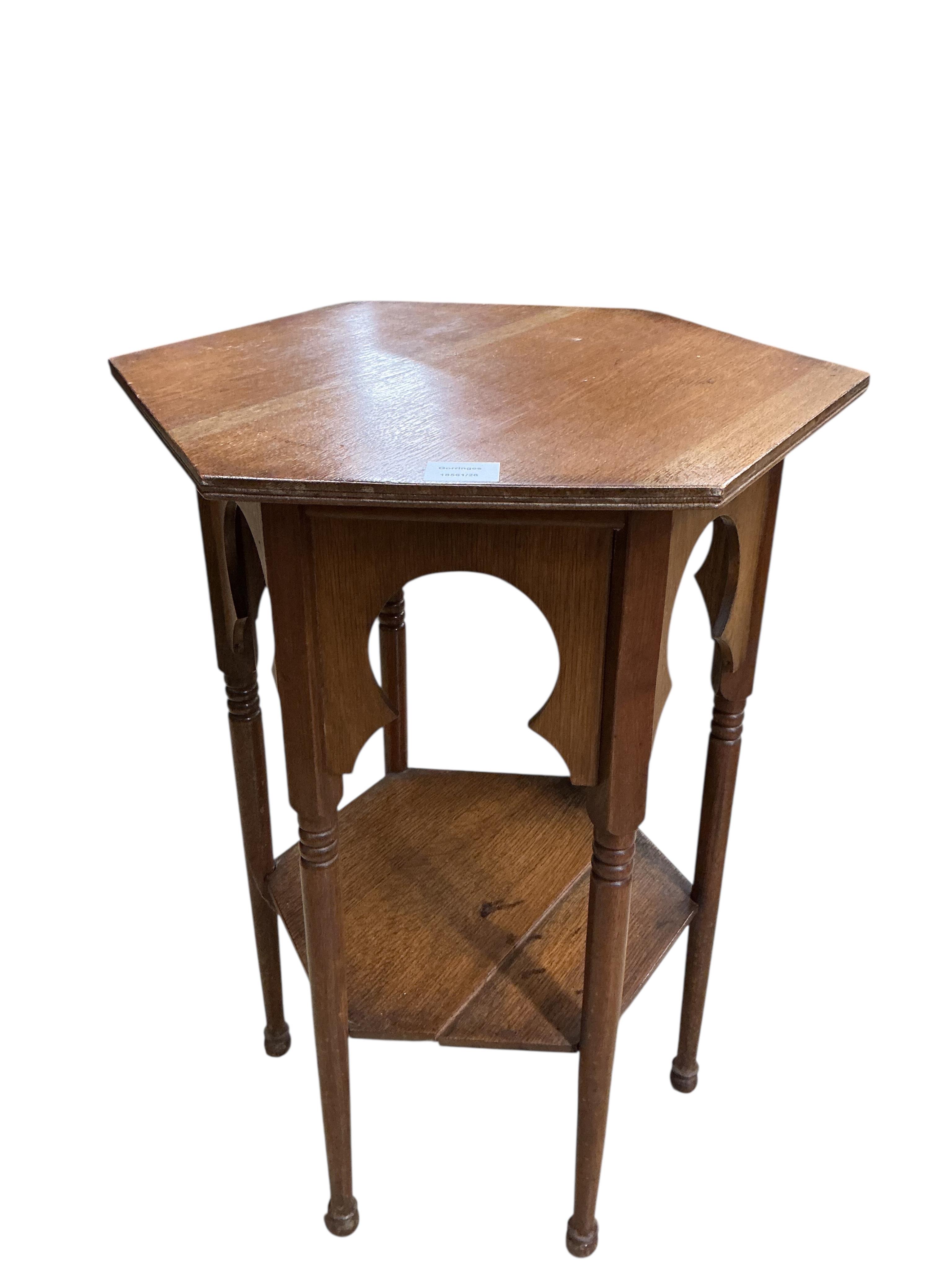 A pair of early 20th century Liberty style hexagonal oak two tier occasional tables, width 48cm, height 71cm